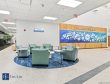 Brown Family YMCA wellness lounge with green seating, small tables and a donor recognition wall.