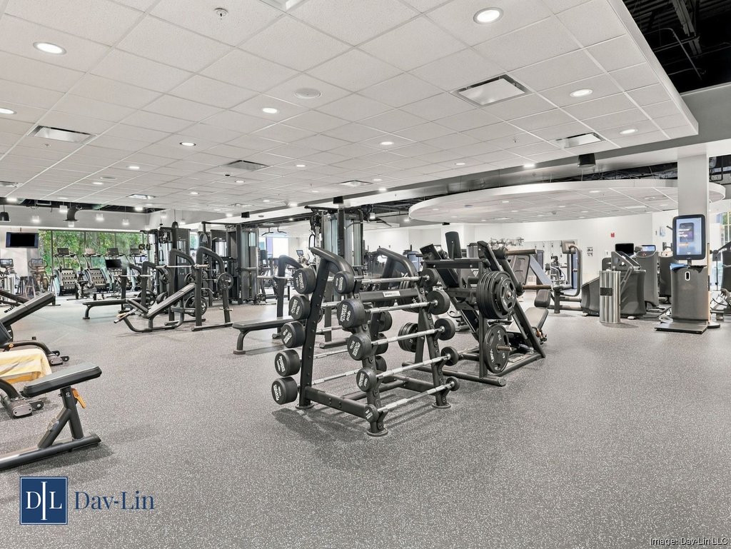 Brown Family YMCA fitness floor with strength-training machines, benches and weight racks.